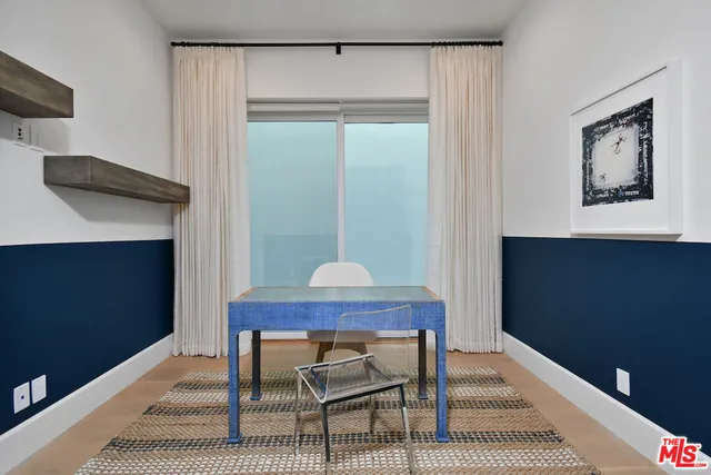 a view of a hallway with wooden floor and stairs