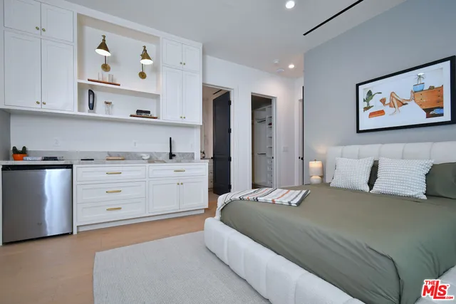 a living room with furniture and large windows