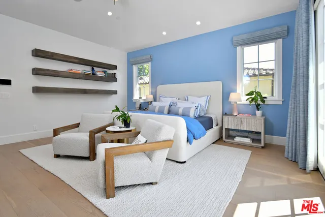 a bath room with a sink and a large mirror