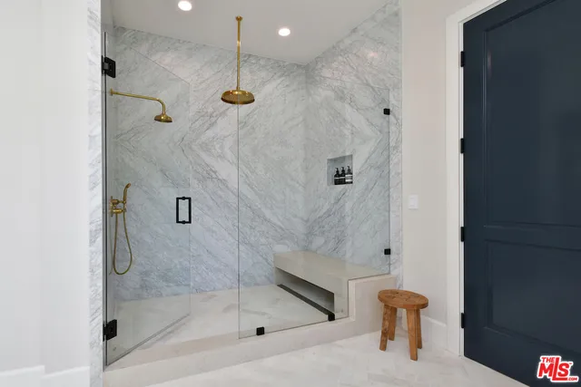 a living room with a couch and a potted plant