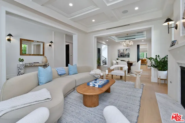 a living room with furniture and view of kitchen