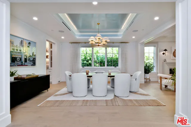 a view of a dining room with furniture and chandelier