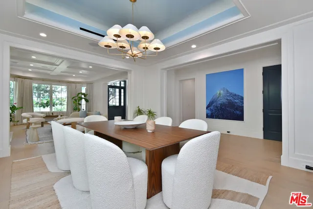 a living room with furniture a fireplace and a potted plant