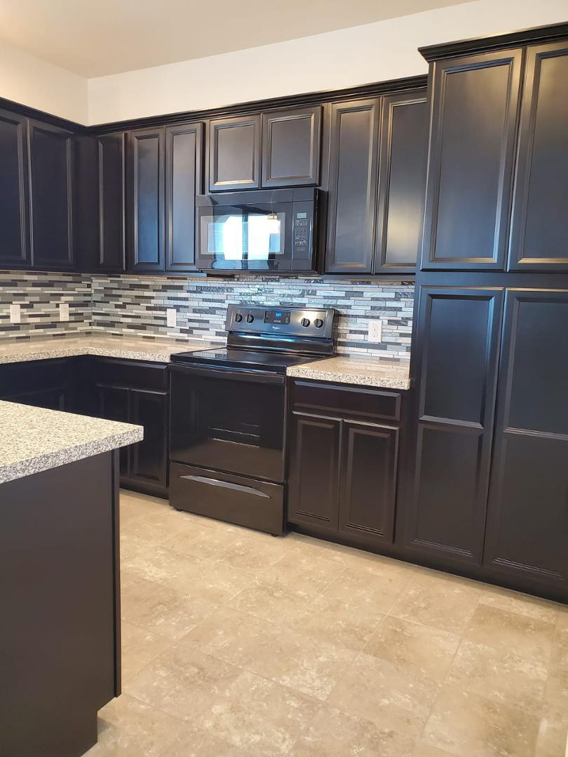 3900 East Baseline Road, Unit 118 Phoenix, AZ 85042 - Photo 28 of 32 a kitchen with stainless steel appliances granite countertop a stove a refrigerator and a sink