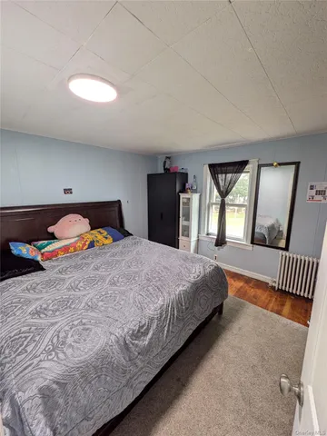 a bedroom with a bed and a mirror