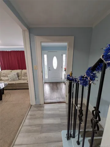 a view of a livingroom with wooden floor and stairs