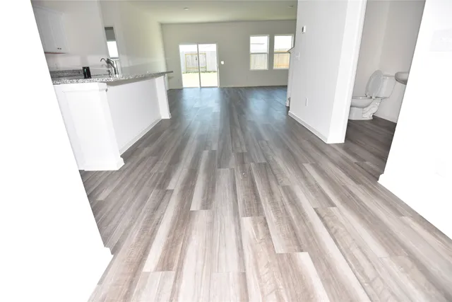 a kitchen with cabinets and wooden floor