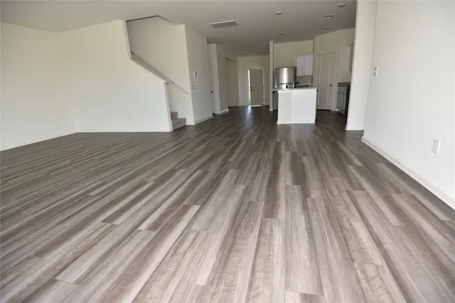 a view of a room with wooden floor
