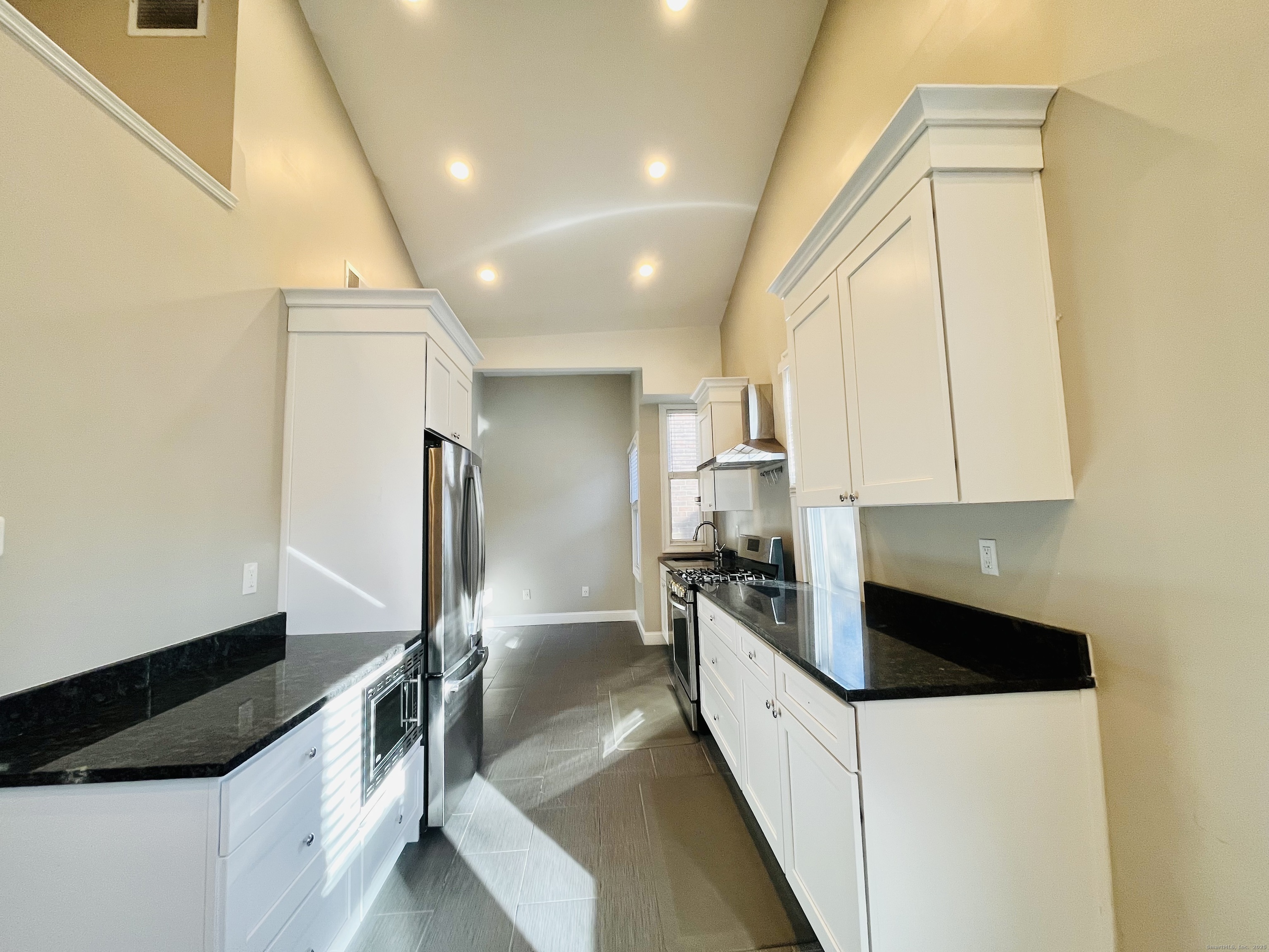 597 Chapel Street, Unit 2FR New Haven, CT 06511 - Photo 8 of 15 a kitchen with stainless steel appliances a refrigerator sink and white cabinets