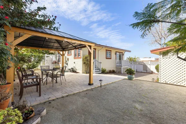 a view of a backyard with a patio and a garden
