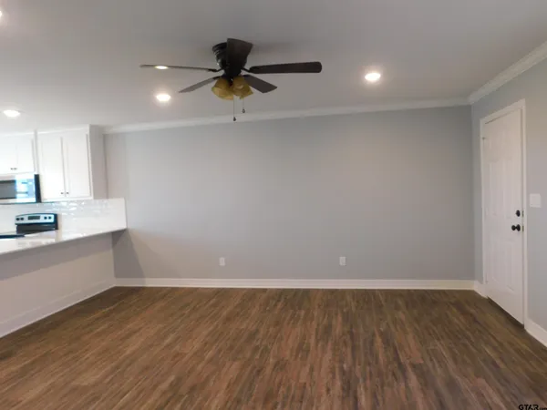 a view of a kitchen with a sink and wooden floor