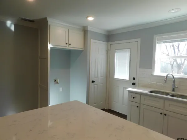 a kitchen with a sink and cabinets