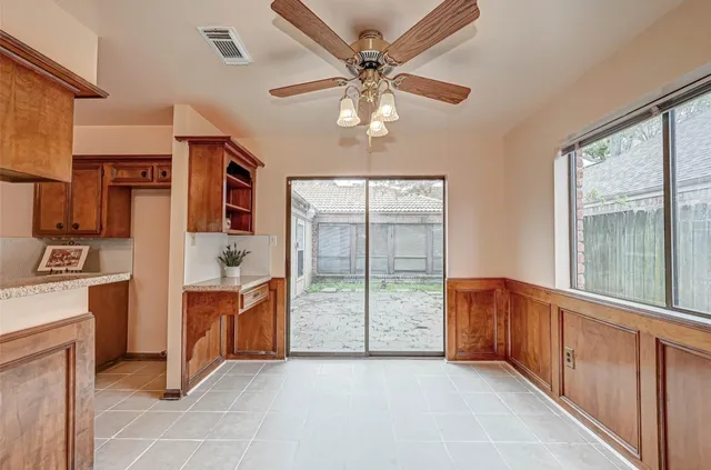 a view of kitchen with furniture and a ceiling fan
