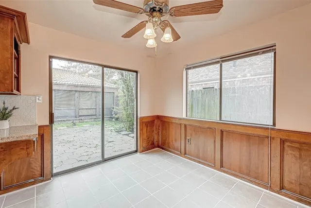 a view of an empty room with window chandelier