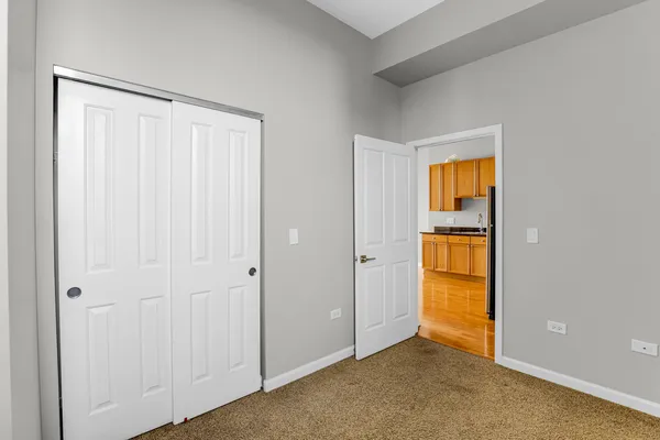 a view of an empty room with closet area