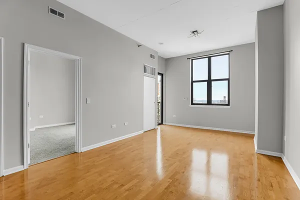 an empty room with windows and closet