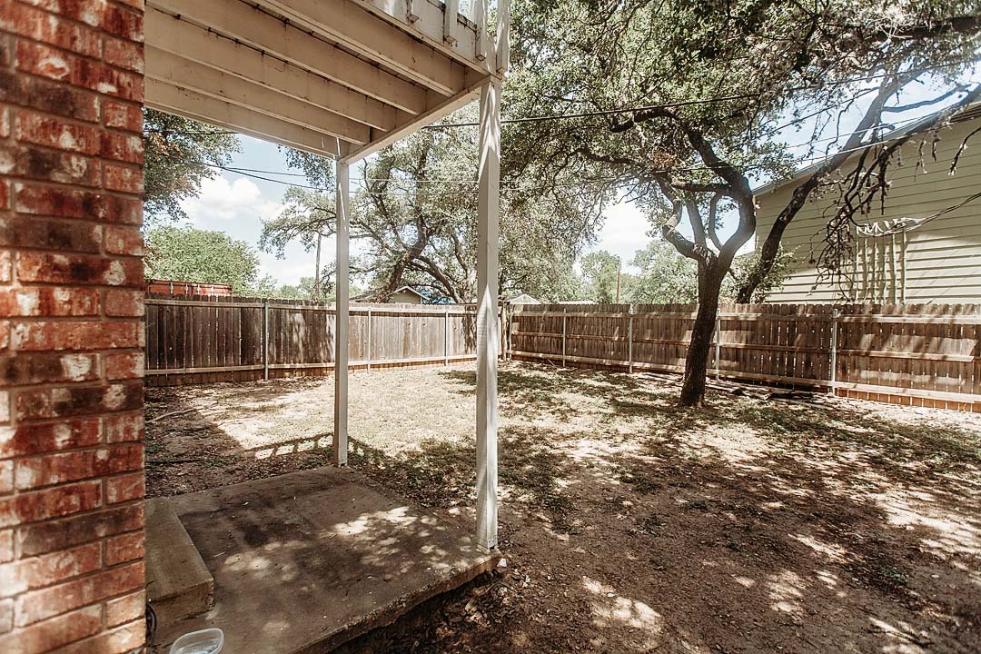 3712 Menchaca Road, Unit 7 Austin, TX 78704 - Photo 12 of 13 Mature shade trees and a privacy fence frame the outdoor space.