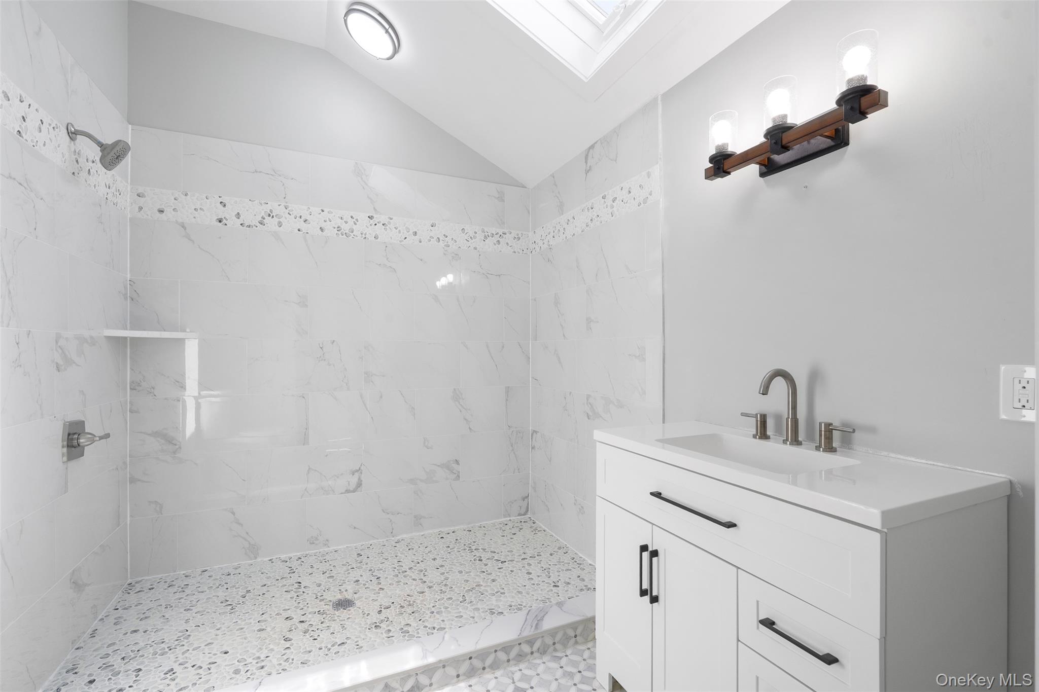 70 Barmore Road LaGrangeville, NY 12540 - Photo 19 of 47 Bathroom with a skylight, a tile shower, lofted ceiling, and vanity