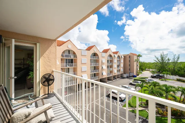 a view of a chair and tables in the balcony