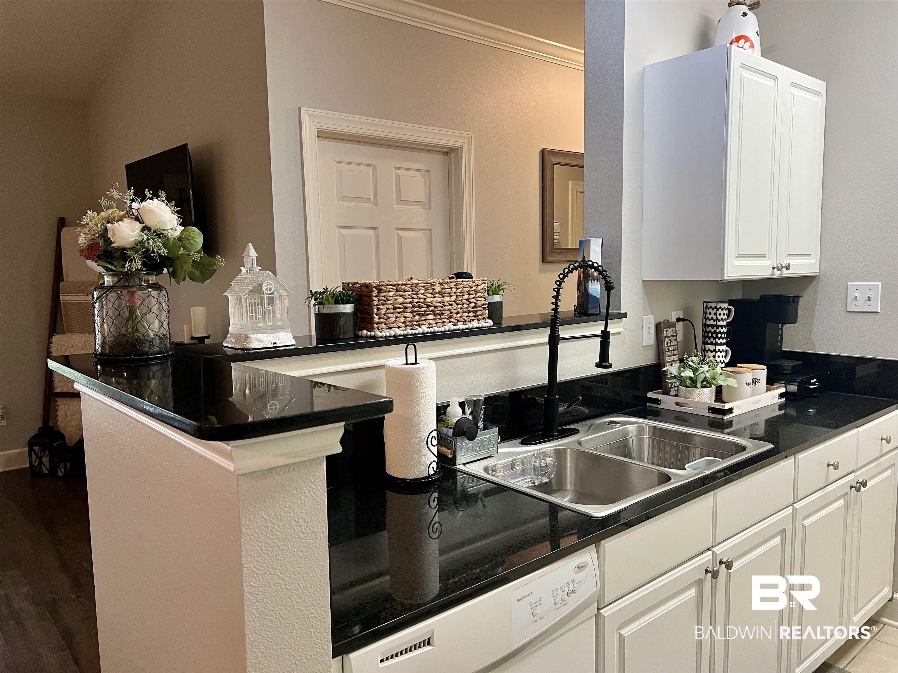 450 Park Avenue, Unit 808 Foley, AL 36535 - Photo 11 of 38 Kitchen featuring sink, crown molding, white cabinetry, white dishwasher, and kitchen peninsula