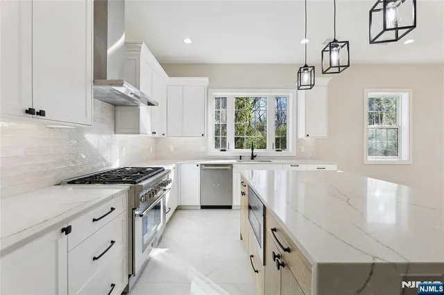 a kitchen with a stove a sink and a refrigerator