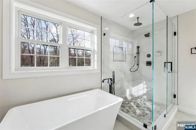 a bathroom with a granite countertop sink a toilet and shower