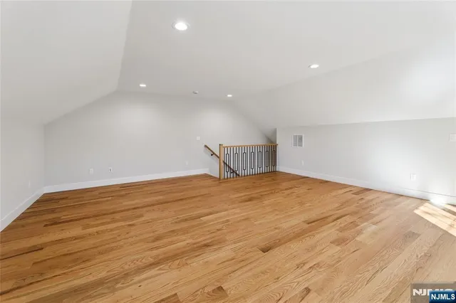 a view of a room with wooden floor and a sink