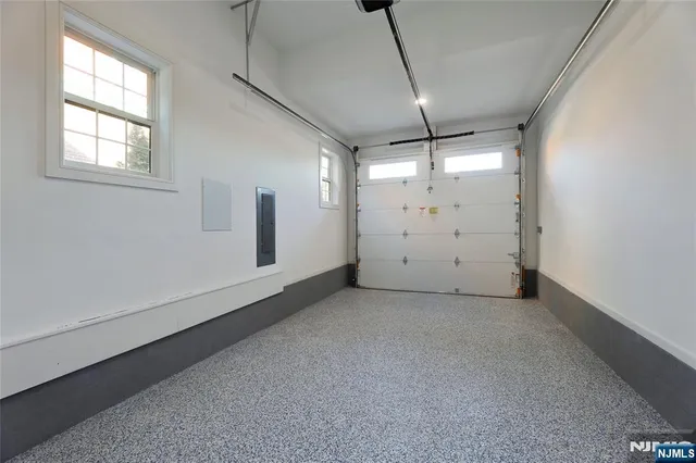 an empty room with windows and ceiling fan