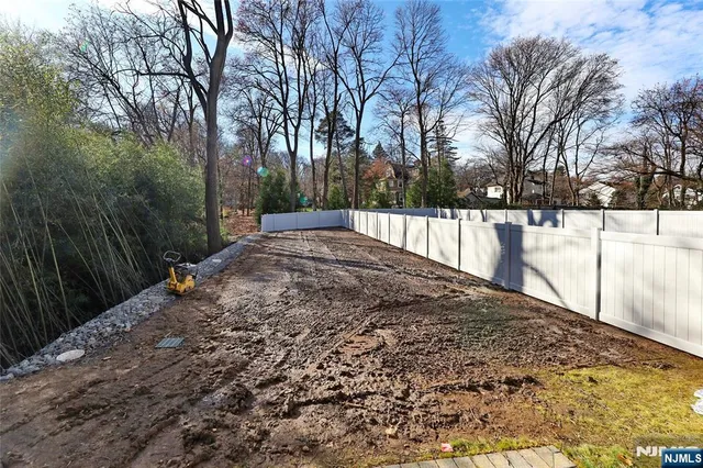 a view of a backyard with snow on the road