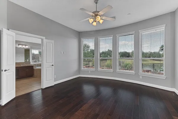 wooden floor with white cabinets