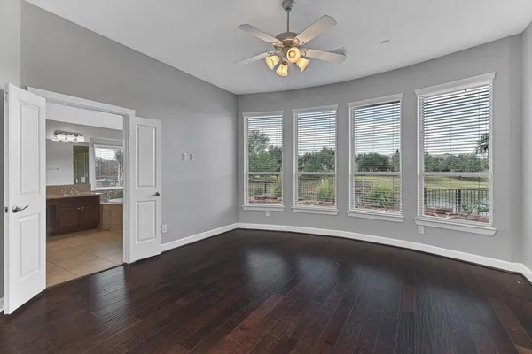 a view of a livingroom with wooden floor and a ceiling fan