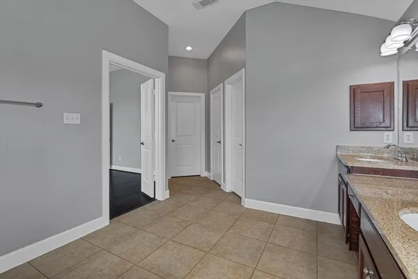 an empty room with closet and mirror