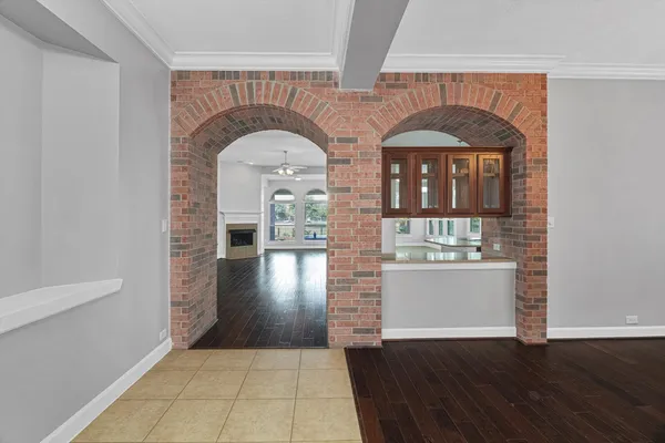 a view of empty room with wooden floor and fireplace