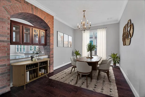 a view of a room with wooden floors and chandelier