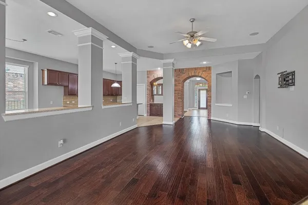 a kitchen with stainless steel appliances granite countertop a sink counter space cabinets and a view of living room
