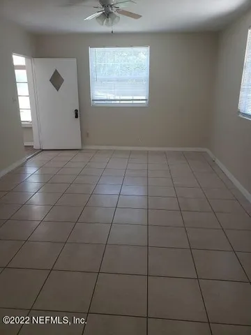 a view of a livingroom with an empty space and a window