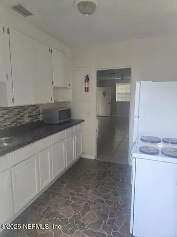 a bathroom with a sink toilet and window