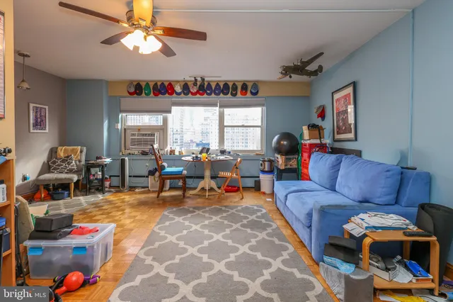a living room with furniture a fireplace and a window