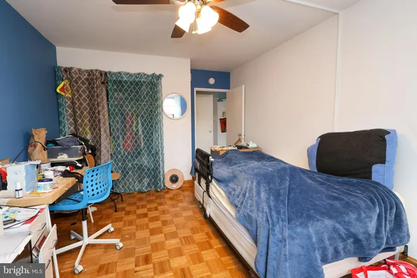 a bedroom with bed and a chandelier