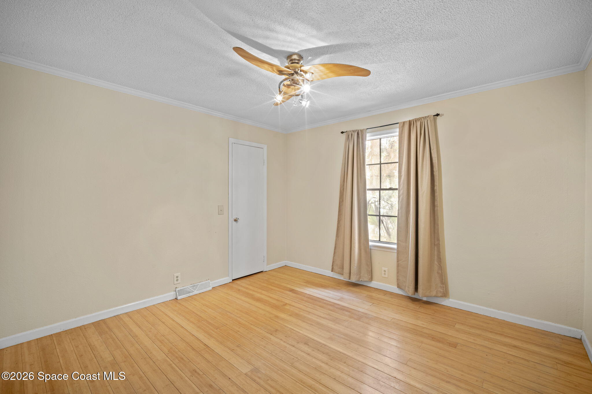 325 East Hall Road Merritt Island, FL 32953 - Photo 18 of 29 wooden floor in an empty room with a window