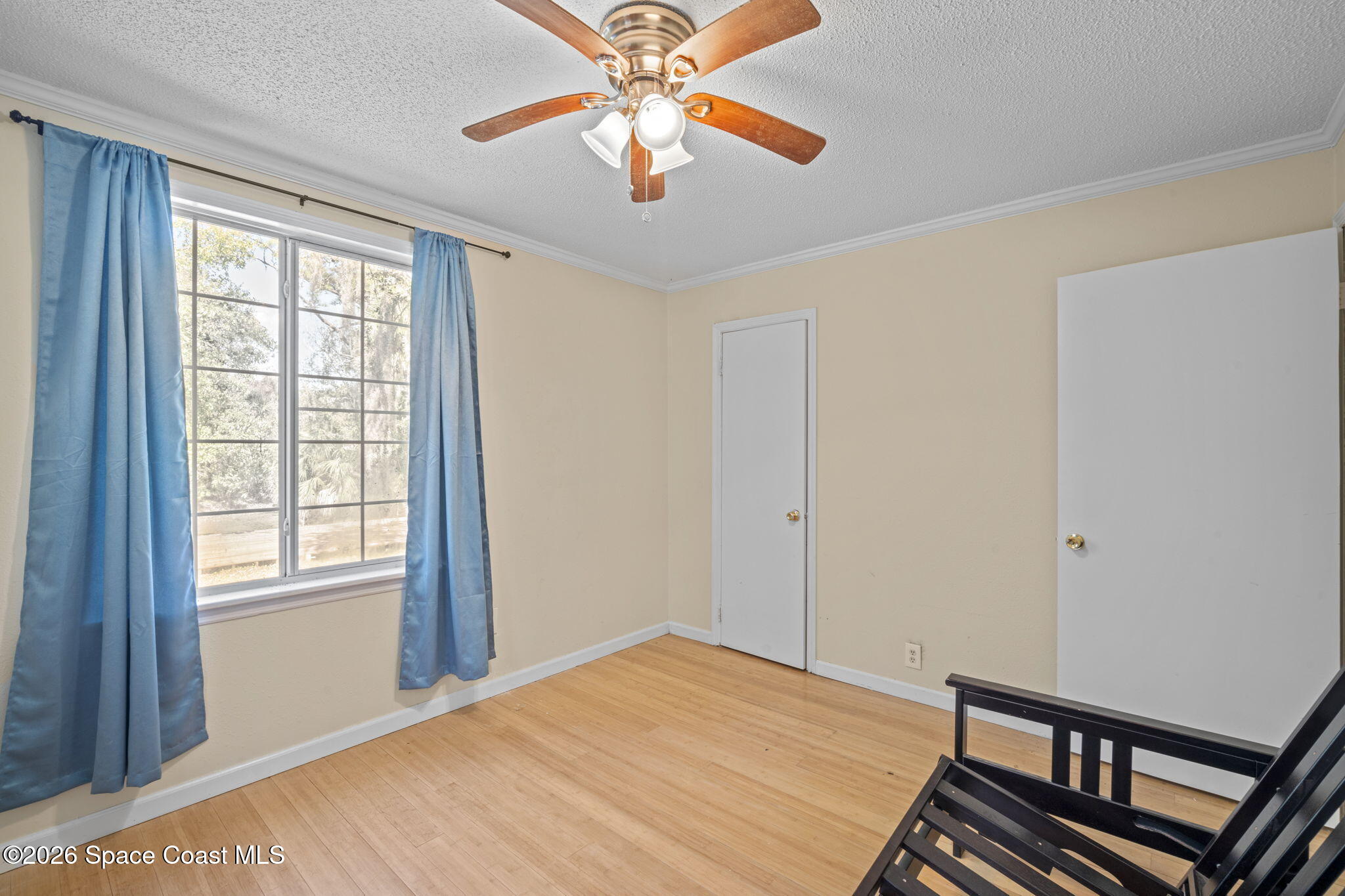 325 East Hall Road Merritt Island, FL 32953 - Photo 21 of 29 a view of an empty room with window and a chandelier fan