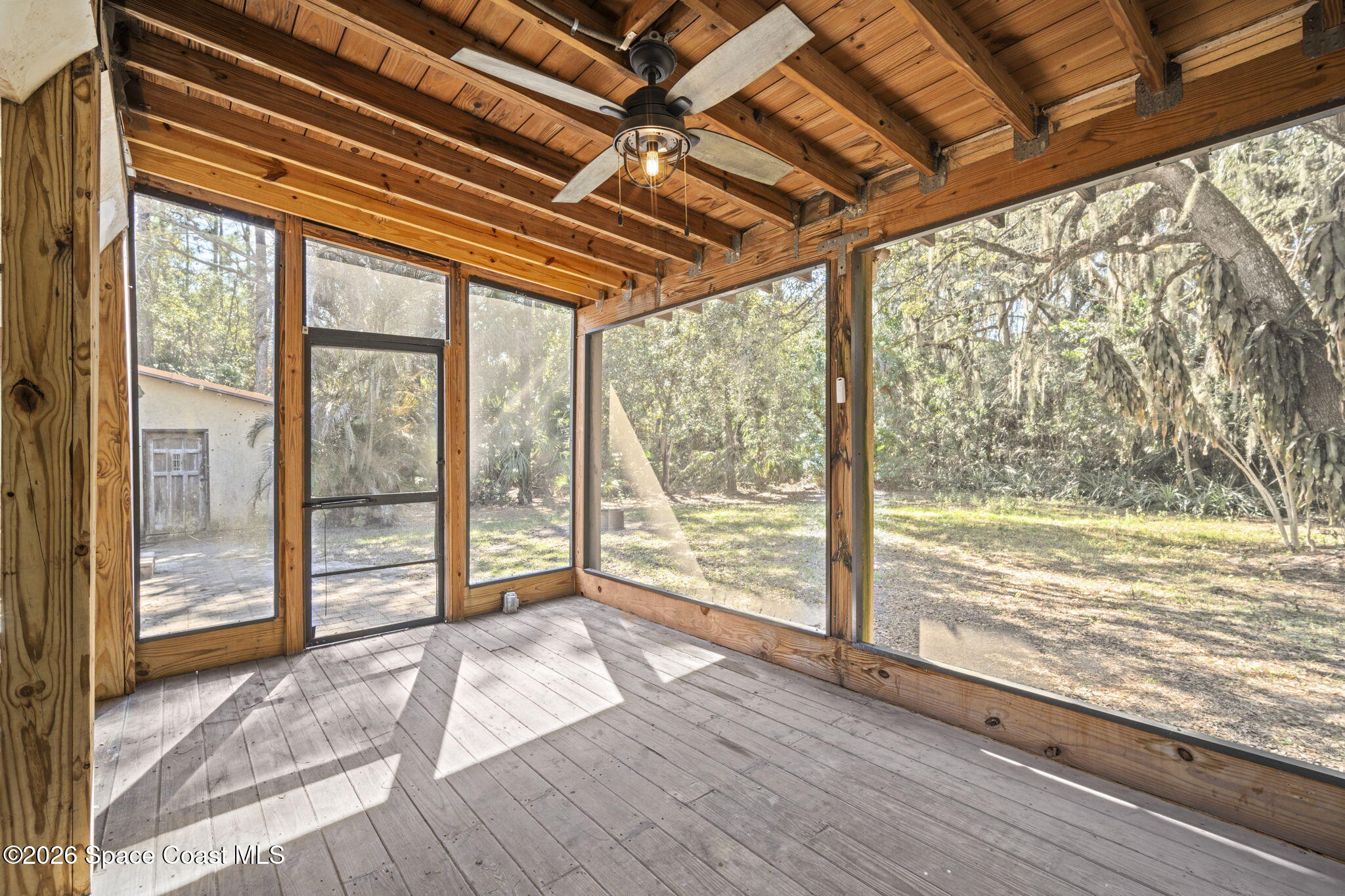 325 East Hall Road Merritt Island, FL 32953 - Photo 24 of 29 a view of an empty room with wooden floor and a window