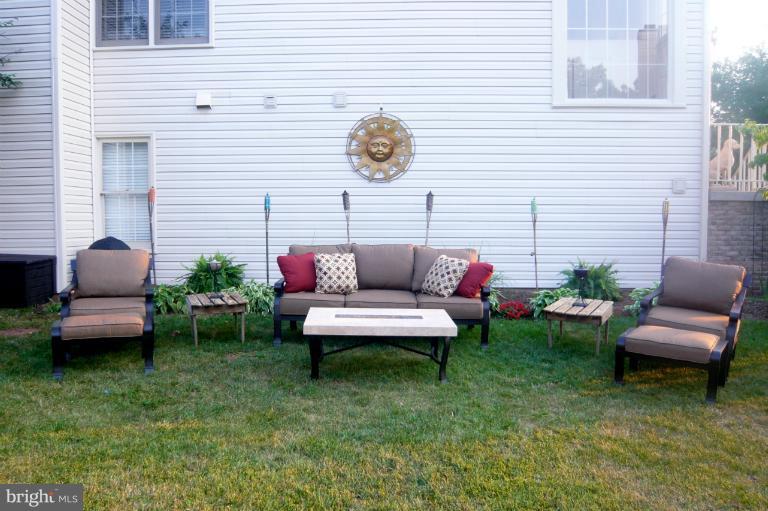 a view of a patio with couches chairs and a potted plant