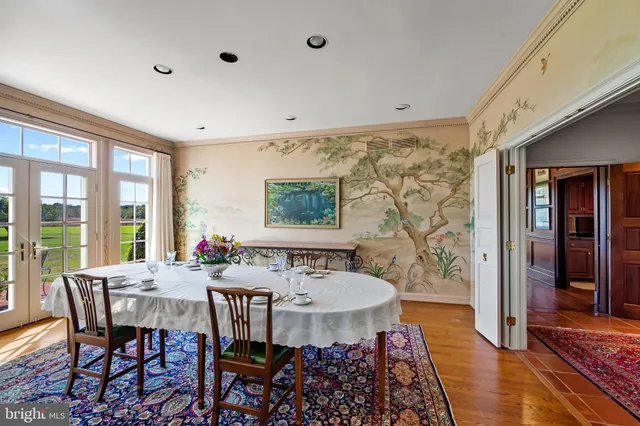 a living room with furniture a fireplace and large windows