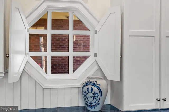 a bed sitting in a bedroom next to a window and a lamp