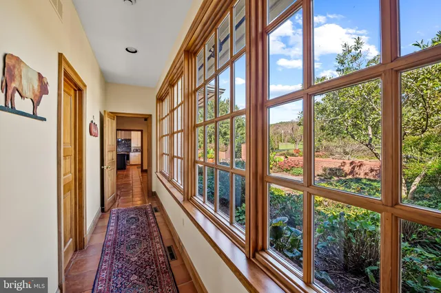 a bedroom with two beds and a large window