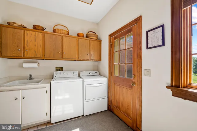 a bathroom with a tub a sink and mirror