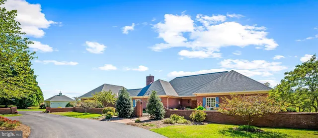a front view of house with yard and outdoor seating