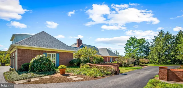 a view of a wooden door with a bench in front of it