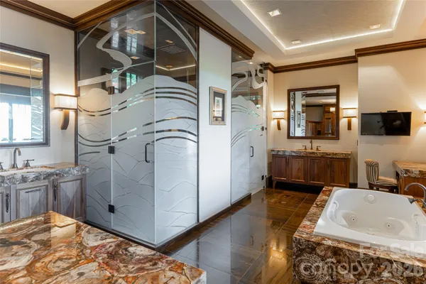 a bathroom with a tub sink and mirror